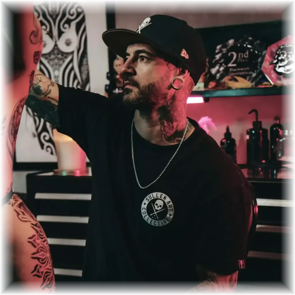 Duk Tattoo working on a client in his tattoo studio in Boca Raton, Florida
