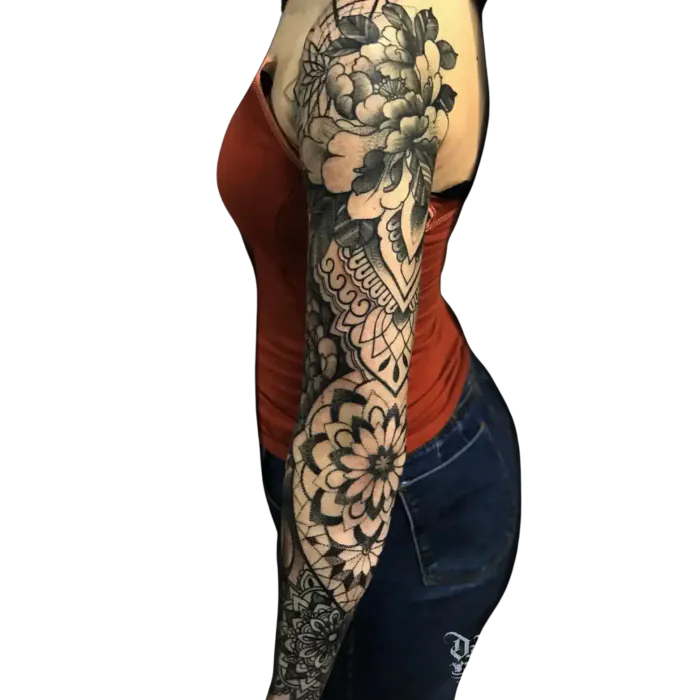 Womens full arm sleeve tattoo mixing black and grey flowers with geometric mandalas by Duk Tattoo, Florida
