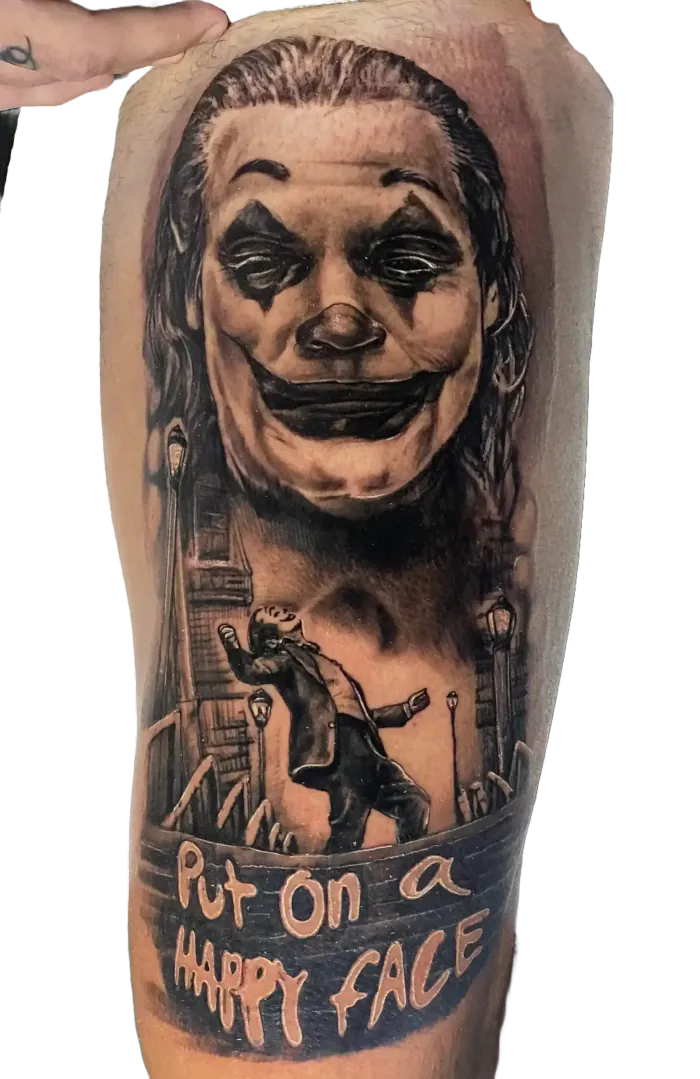 Black and grey Joker portrait tattoo with the quote Put on a happy face, by Duk Tattoo, Boca Raton, Florida