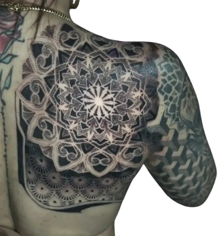 Shoulder and chest mandala shield tattoo with geometric honeycomb dotwork by Duk Tattoo, Florida